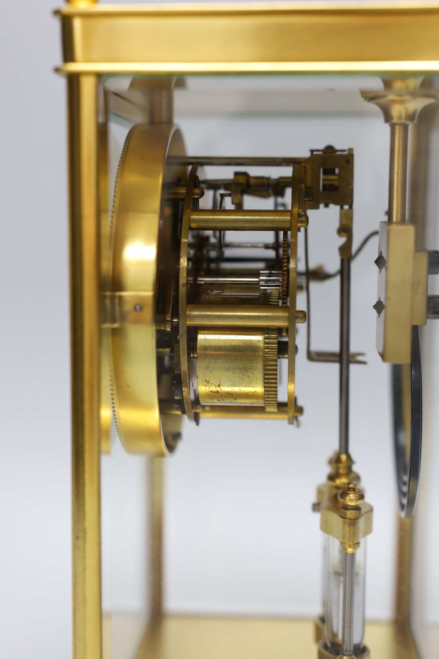 A late 19th century French four glass mantel clock, mercury pendulum and key, 26cm tall